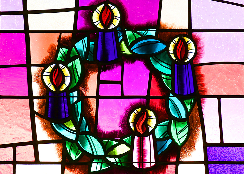 An Advent wreath is depicted in a stained-glass window at Christ the King Church in Commack, New York. (CNS/Gregory A. Shemitz)