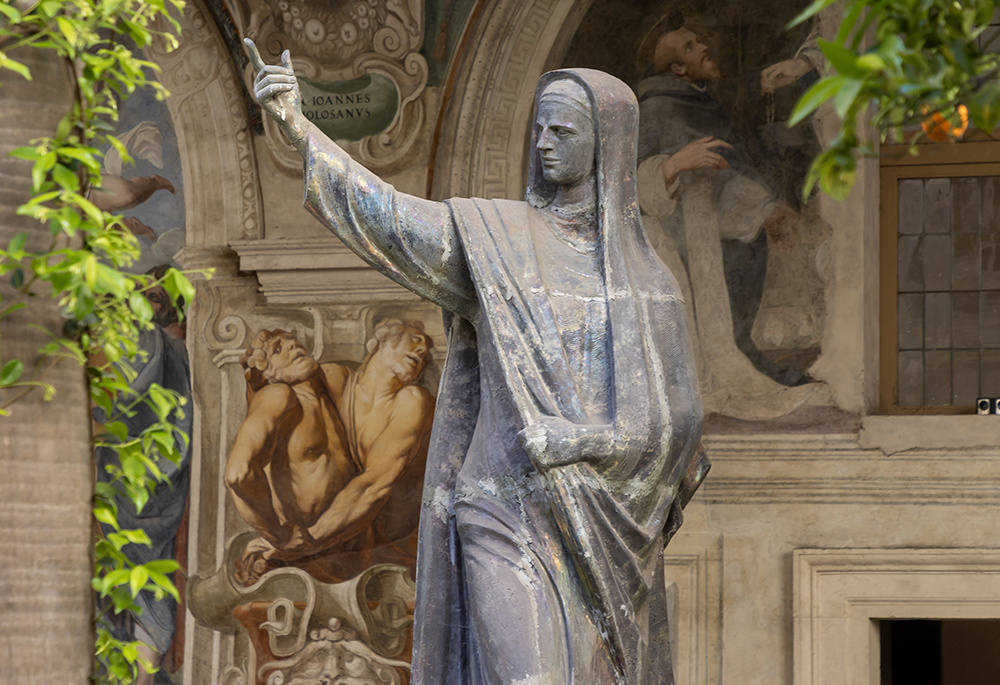 A statue of St. Catherine of Siena is seen in the cloister of the Dominican friars' convent next to the Basilica of Santa Maria Sopra Minerva in Rome April 18, 2024. On Aug. 3, 2025, Sr. Annie Killian professed perpetual vows as a Dominican Sister of Peace. The sisters shared with her the charism from Sts. Dominic and Catherine. (CNS/Pablo Esparza)