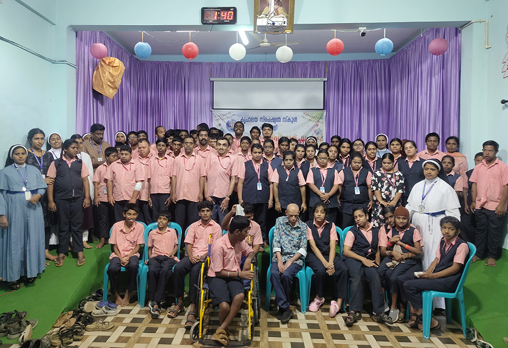 Students of Kripalaya Special School at Pulpally, Wayanad, Kerala, southwestern India, pose with their teachers for a group photo at the school auditorium. (George Kommattam)