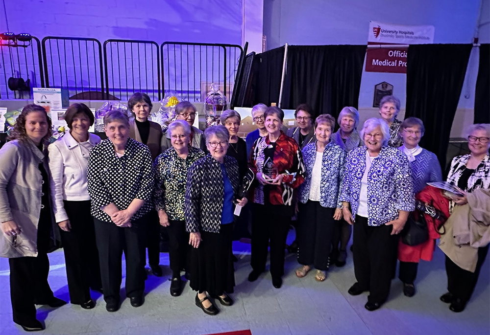 Sr. Erin Zubal, far left, poses with many of her sisters at an event honoring Sr. Susan Zion for her hard work and commitment to ministry. Zion, fifth from the right, front row, was inducted into Villa Angela-St Joseph High School’s Hall of Fame at Villa Angela-St Joseph High School, Cleveland, Ohio, April 22, 2023.  You can always count on the Ursulines to show up for each other, Sister Erin writes. (Courtesy of Erin Zubal)