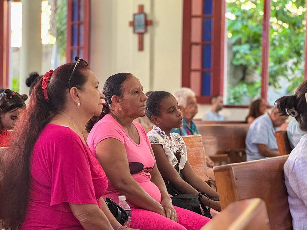 Churchgoers at Our Lady of Mount Carmel in Cueto, in eastern Cuba, listen during Sunday Mass Nov. 16, 2025. The church normally fills up, parishioners said, but many members were absent as they’ve fallen ill to mosquito-transmitted viruses. (NCR photo/Rhina Guidos)