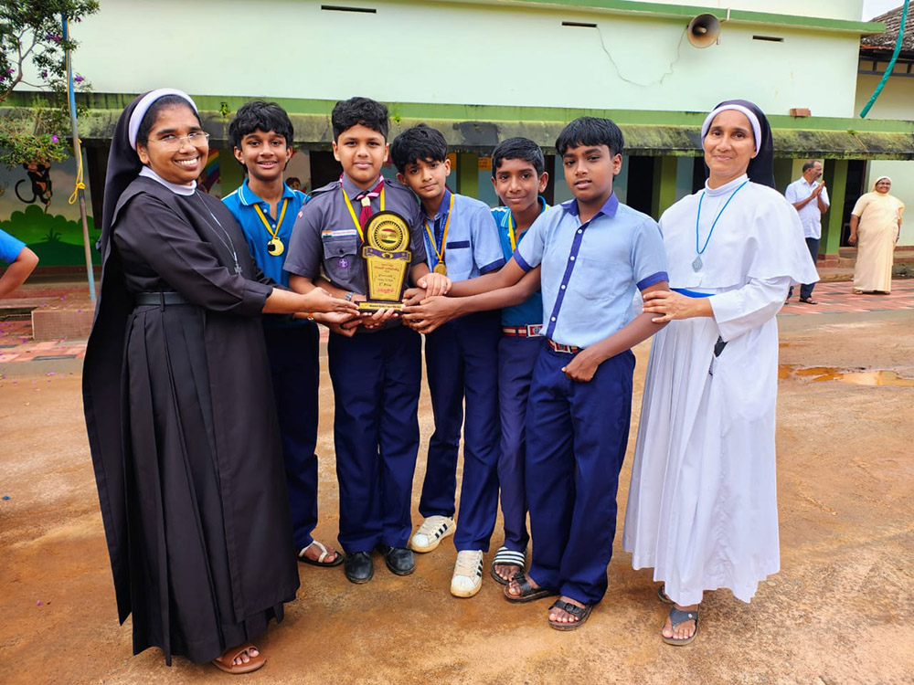 Adoration Sr. Sabina Joseph (right) and Carmelite Sr. Siji Joseph (left) congratulate the school’s tug-of-war team for winning second prize in the district-level competition in 2025. (Courtesy of Sabina Joseph)