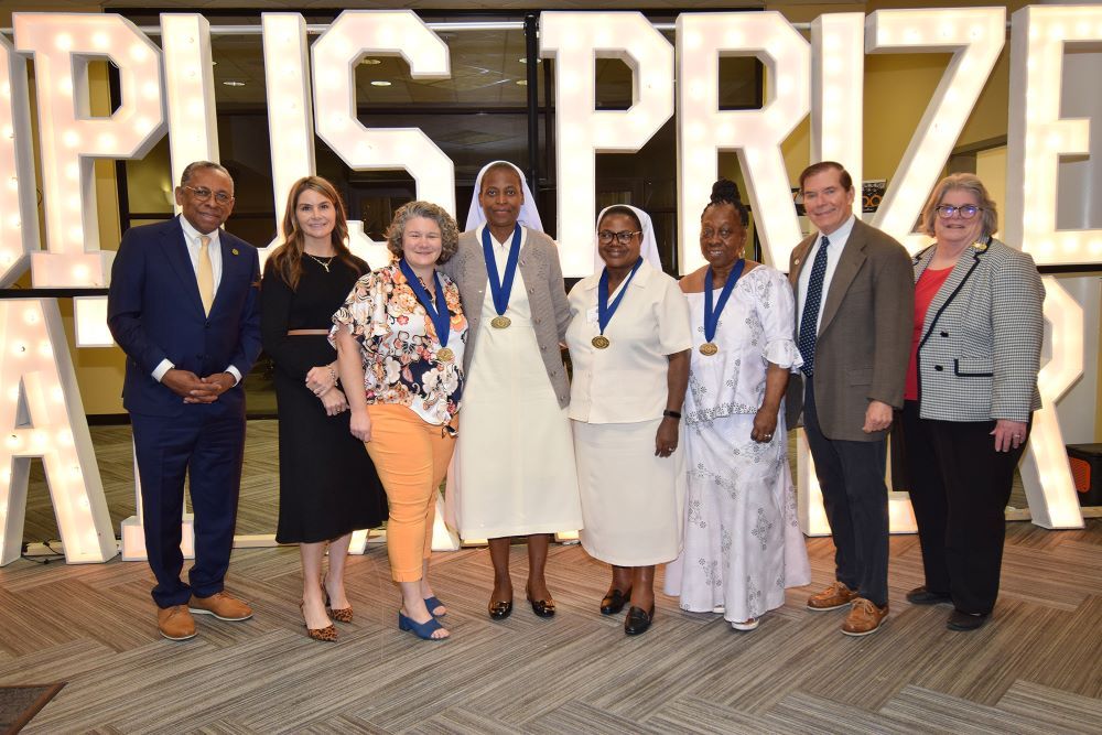 Sr. Christabel Juunza Mwangan, center left, and Sr. Rosalia Sakayombo are pictured with others at 2025 Opus Prize event. 