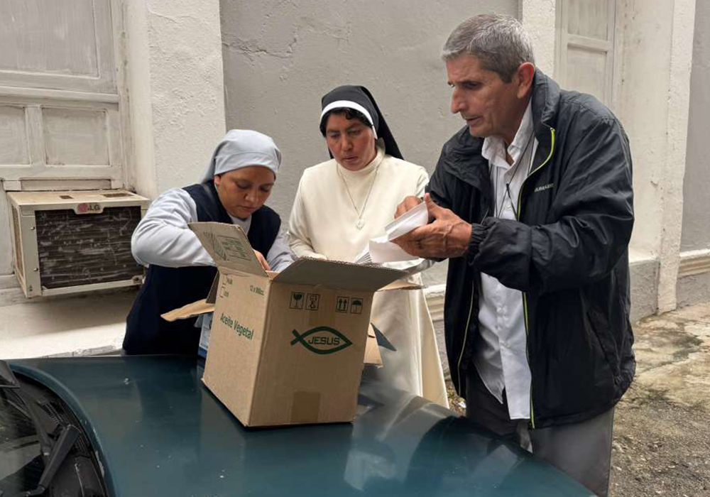 Sr. Glendes Romero Miguel, left, of the Congregation of Martha and Mary, Mercedarian Sr. María Luz Ramírez, and Auxiliary Bishop Marcos Pirán of the Diocese of Holguín, gently wrap eggs in tissue paper Nov. 14, 2025, in Ciego de Ávila, Cuba. The missionary sisters bought eggs before getting to the eastern part of the island, where damage from Hurricane Melissa in late October wiped out crops and sent food prices skyrocketing. (GSR photo/Rhina Guidos)