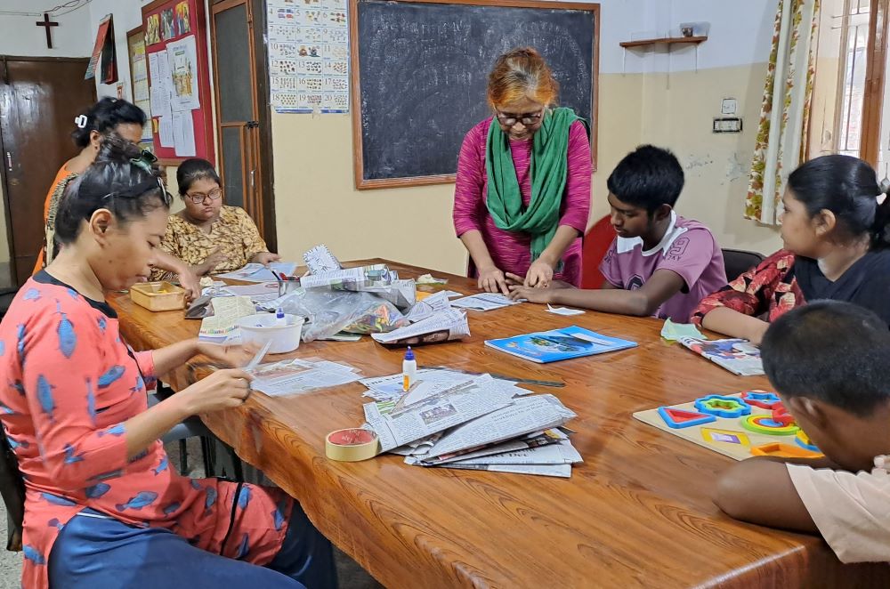 Teachers work with children at one of the centers for children with disabilities in Tejkunipara, Dhaka, run by the Marist Missionary Sisters. (Courtesy of Suporna Rozario)