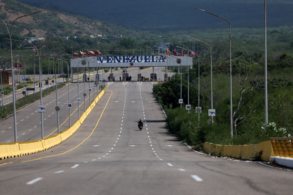 People ride a motorbike along an empty road at the Tienditas Bridge border between Venezuela and Colombia, in Cucuta, Colombia, Jan. 4, following U.S. strikes on Venezuela where President Nicolas Maduro and his wife, Cilia Flores, were captured the previous day. (OSV News/Reuters/Luisa Gonzalez)