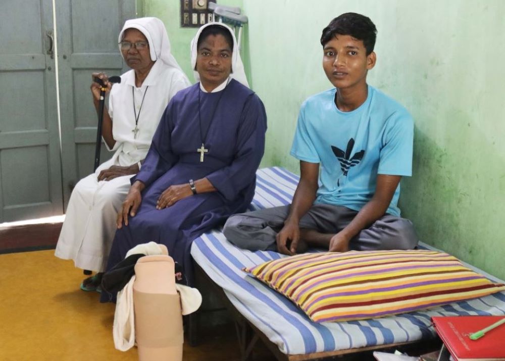 Maria Bambina Srs. Agustina Tudu, 69 (left), and Flora Rozario, 45, care for Mohammad Sowrav, a patient in the sisters' tuberculosis shelter in the Diocese of Rajshahi. (Stephan Uttom Rozario)