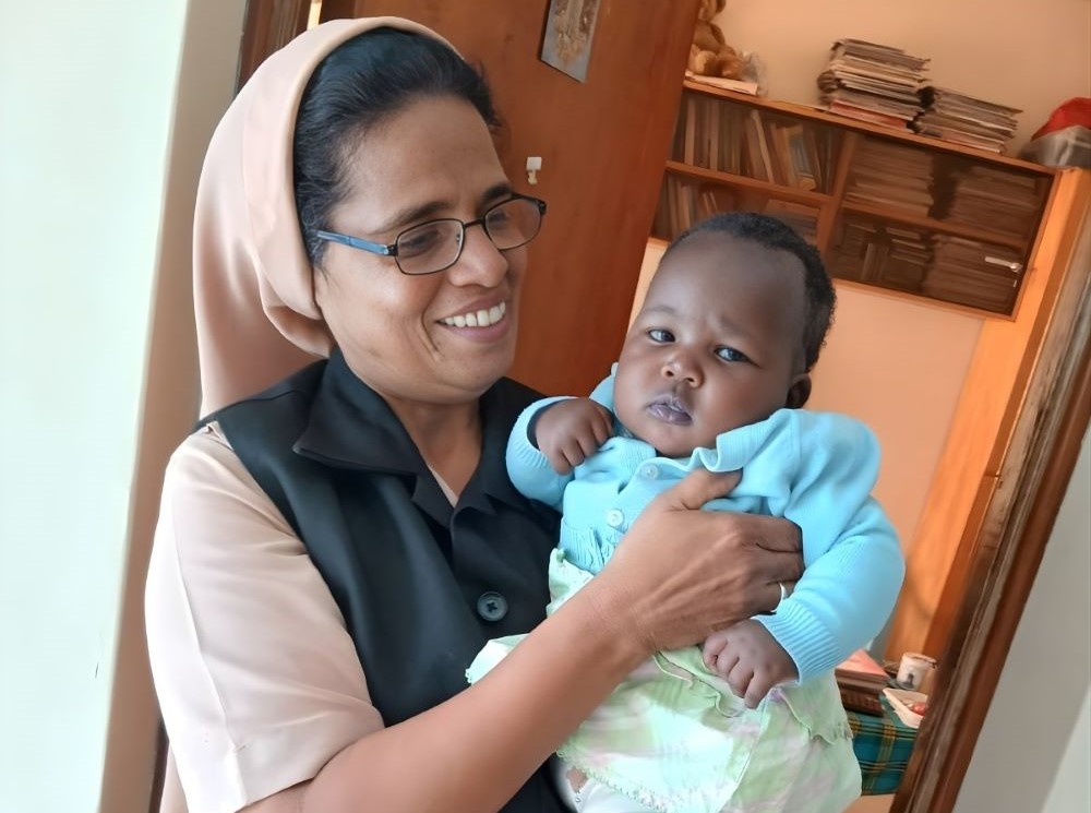 Sr. Alphonsa Parathur, of the Society of Helpers of Mary, poses with a child who was recently welcomed into the Holy Family Children's Home in Nakuru, Kenya. Parathur manages the home. (Courtesy of Alphonsa Parathur)