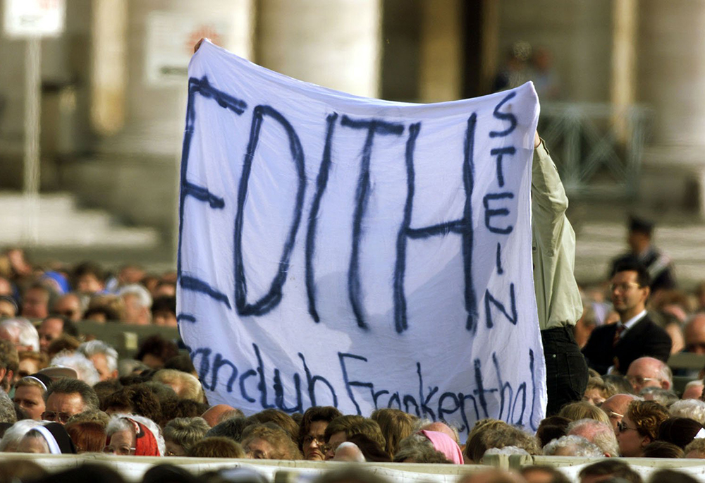 Pilgrims hold up a banner in St. Peter's Square during the canonization of Edith Stein Oct. 11, 1998. (CNS/Reuters)