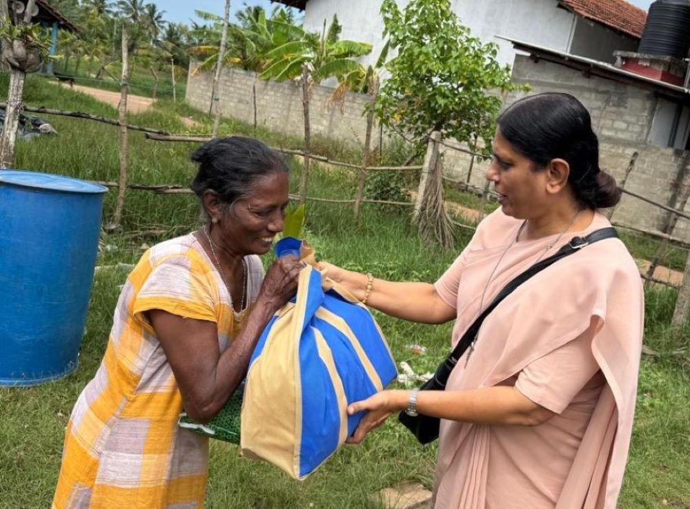 Apostolic Carmel Sr. Maria Nirmalini of India, the congregation's superior general, visits a person affected by Cyclone Ditwah in Sri Lanka. (Courtesy of Maria Ajantha)