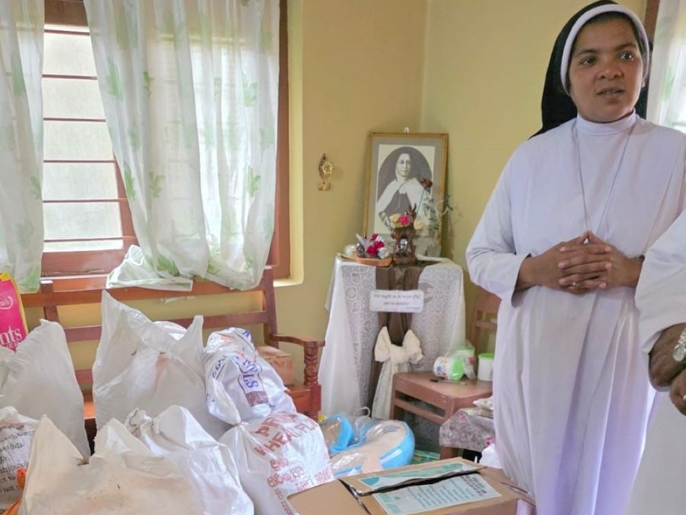 Apostolic Carmel Sr. Maria Ajantha prepares relief materials with villagers in Pussellawa, a hill station in Sri Lanka. (Courtesy of Maria Ajantha)