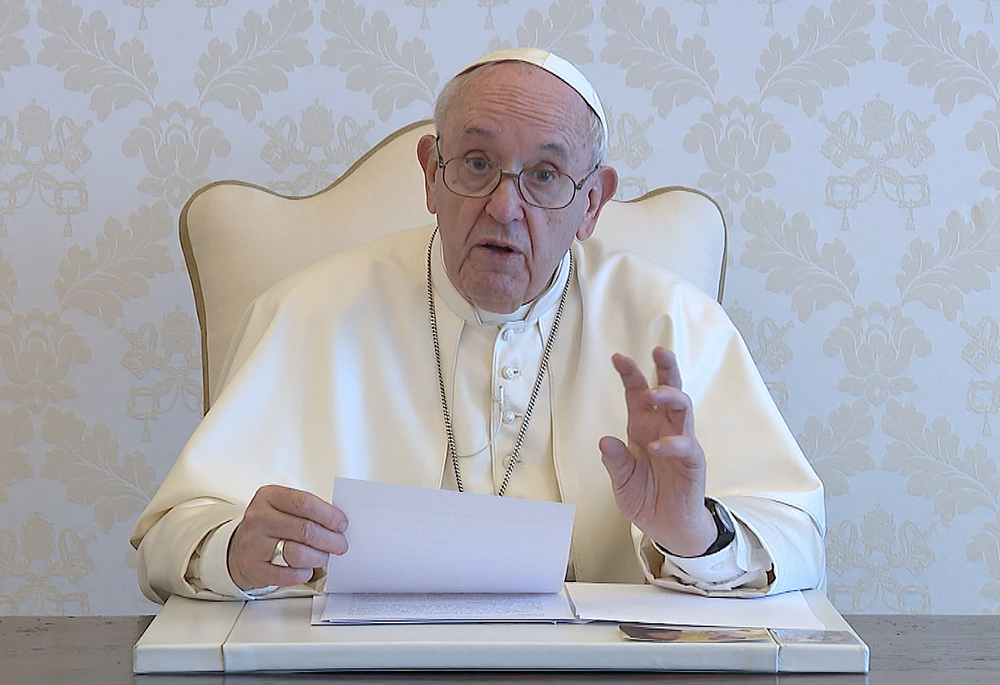 Pope Francis delivers a June 9, 2021, video message to participants of an online forum titled "Where are we with Amoris Laetitia?" dedicated to implementing proposals inspired by his 2016 exhortation of the same name. He said the church must learn to "listen actively to families, and at the same time to involve them as subjects of pastoral care." (CNS screenshot/Vatican Media)