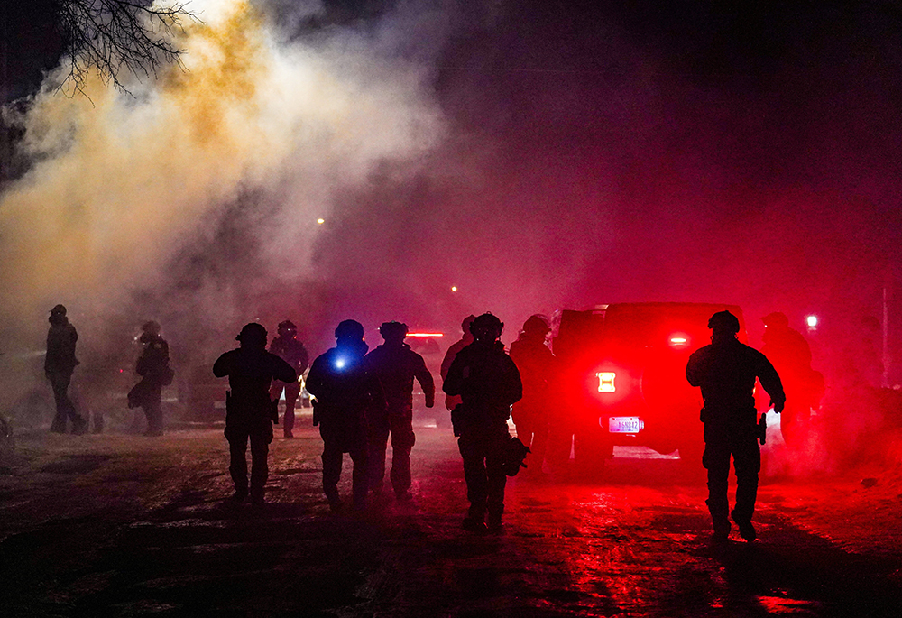 Federal agents stand guard after deploying tear gas as community members protest in Minneapolis Jan. 15, 2026, during ongoing demonstrations against U.S. Immigration and Customs Enforcement. (OSV News/Reuters/Ryan Murphy)
