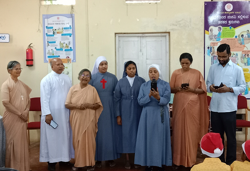 The nun volunteers of the Prison Ministry India with co-founder Fr. Francis Kodiyan, second from left, sing carols at Devanahalli open prison near Bengaluru, the capital of the southwestern Indian state of Karnataka. (Courtesy of Sr. Adele Korah)