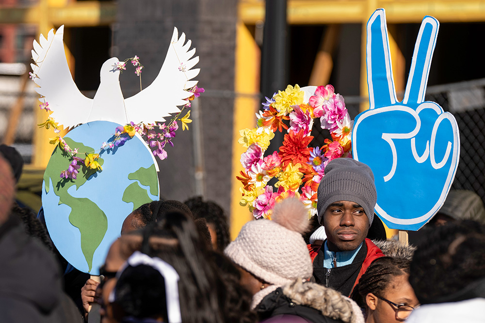 Participants hold peace signs as they gather before the District of Columbia's annual Martin Luther King Day parade Jan. 19, 2026, in Washington. (AP/Mark Schiefelbein)