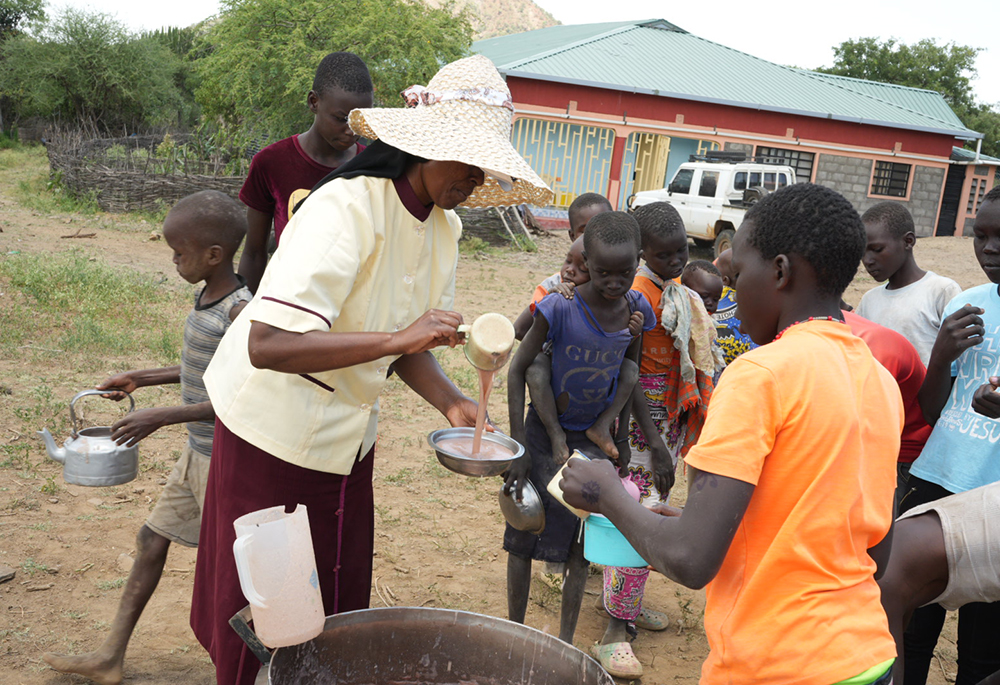 Sr. Jannifer Hiuhu serves porridge to children outside the Incarnate Word Sisters’ convent in northern Kenya. For many students at the congregation’s primary school, the sisters’ "Porridge for Breakfast" program provides their only meal of the day, as nomadic families search for pasture amid a prolonged drought. (GSR photo/Wycliff Peter Oundo)