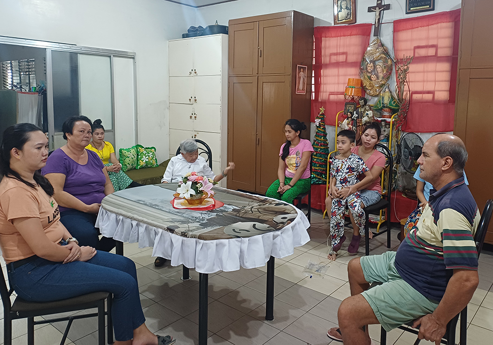 Sr. Clarita Dolencio (in white) sits with the occupants of the shelter she and the Missionary Sisters of the Immaculate Heart of Mary administer in their convent in Quezon City. (Oliver Samson)