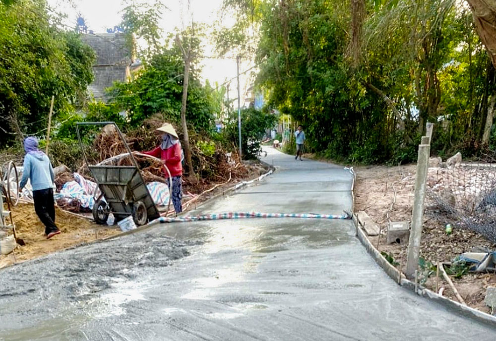 Workers extend the concrete road funded by Lovers of the Holy Cross of Thanh Hoa nuns. The road runs through Thuy Dien cemetery to connect the area with a nearby village in Vietnam Dec. 27, 2025. (Joachim Pham)