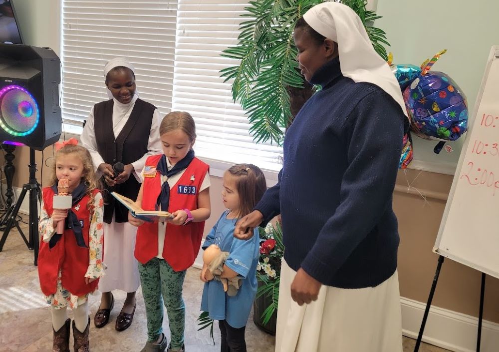 Srs. Imelda Ngwitu and Ancilla Abonyo interact with members of Holy Family Catholic Church's American Heritage Girls troop, a Christian-based organization with a focus on leadership for girls. Through the group, Ngwitu and Abonyo, both from Nairobi, Kenya, got to know the small community of Blakely, Georgia, where they served as members of the Ohio-based Glenmary Home Missioners. Abonyo has since left the area, but Ngwitu still serves there. (Courtesy of Dorann Cobb)