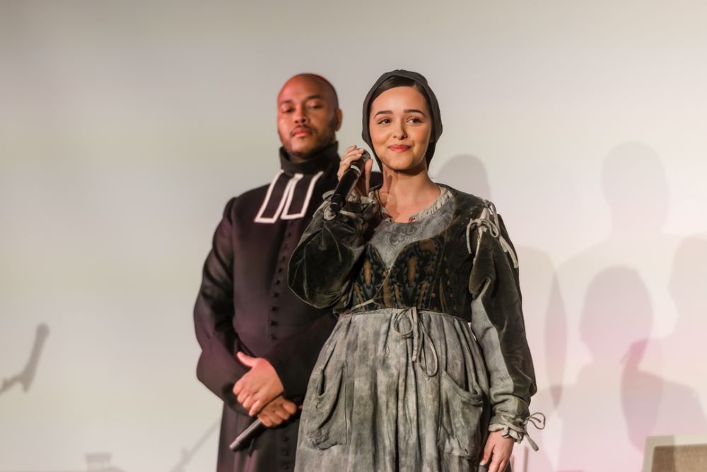 Eyma Scharen (Bernadette Soubirous) performs at a December press event to announce the U.S. premiere of "Bernadette, The Musical." Behind her is Thomas James (Fr. Peyramale). The show premieres Feb. 19 at the Athenaeum Center for Thought & Culture in Chicago. (Courtesy of Maija Martin)