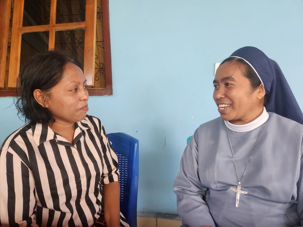 Maria Mater Amabilis, left, a longtime member of a women's self-help group run by TRUK F, speaks with Sr. Fransiska Imakulata, of the Missionary Sisters Servants of the Holy Spirit, who coordinates TRUK F. (GSR photo/Chris Herlinger)