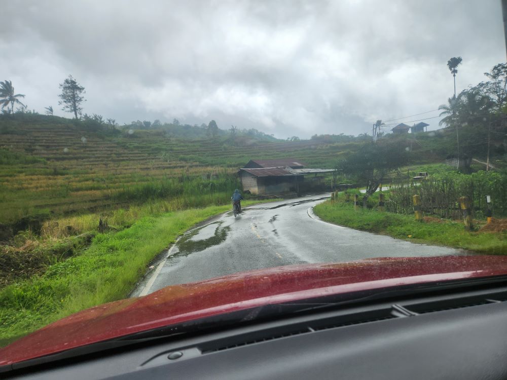 From inside a car, Indonesia's rainy season is evident on the road on the island of Flores. (GSR photo/Chris Herlinger)