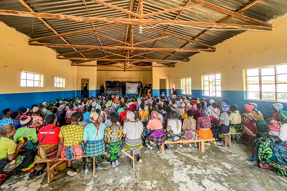 Community members in Malawi listen to a Watts of Love financial literacy training before receiving solar lights during a four-day session at Mponela Lodge in October 2025. The training focuses on saving money formerly spent on kerosene or batteries, investing in livestock and using extended hours of light to generate additional income. (Courtesy of Watts of Love)