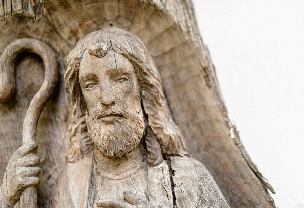 Jesus the Good Shepherd, carved in wood (Unsplash/Karl Raymund Catabas)