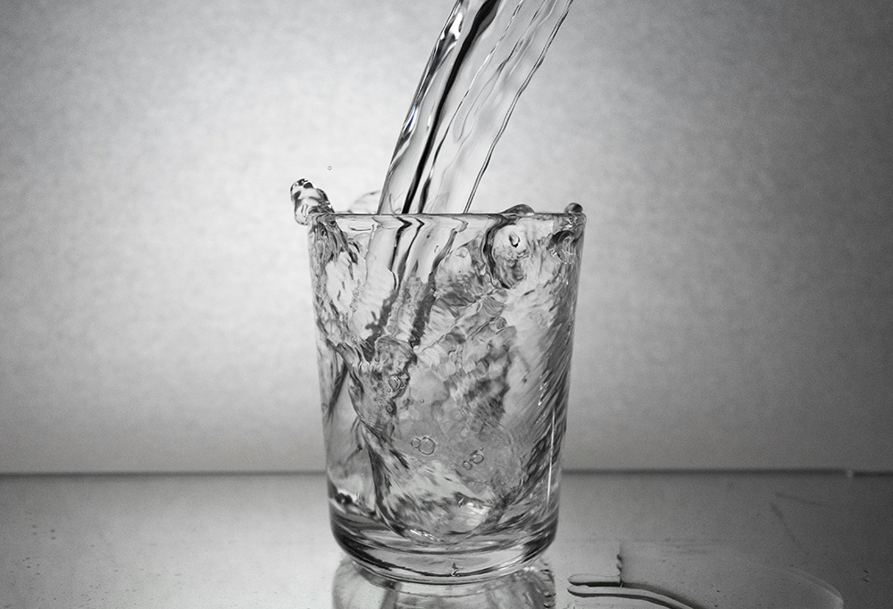 Water being poured into a glass (Unsplash/Siyavash Lolo)