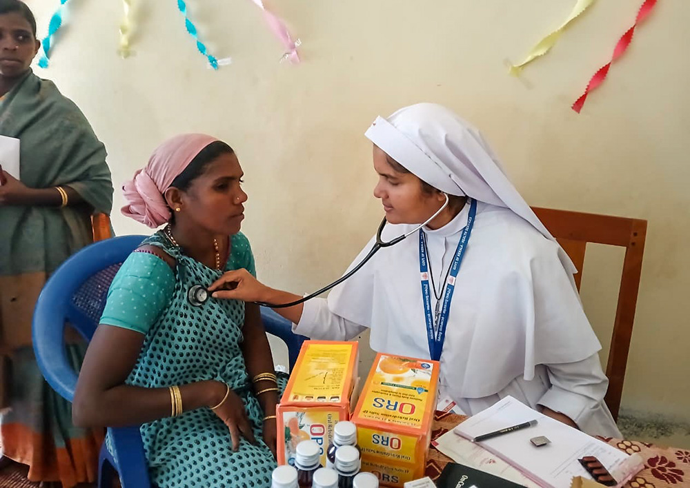 Sr. Jean Rose, a member of the Sisters of the Destitute and a medical doctor, treats a tribal woman at the government Community Health Centre in Marayoor, a remote village in the Idukki district of Kerala, southwestern India. (Courtesy of Jean Rose)