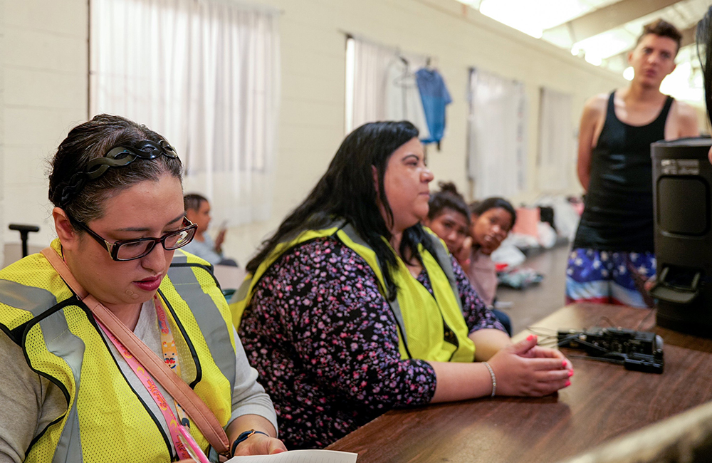 Imelda Maynard, director of legal services of Estrella del Paso (formerly Diocesan Migrant and Refugee Services), and Melissa López, executive director, provide legal information to migrants in a migrant shelter in El Paso, Texas. (OSV News/Courtesy of Diocesan Migrant and Refugee Services, Inc. of El Paso)