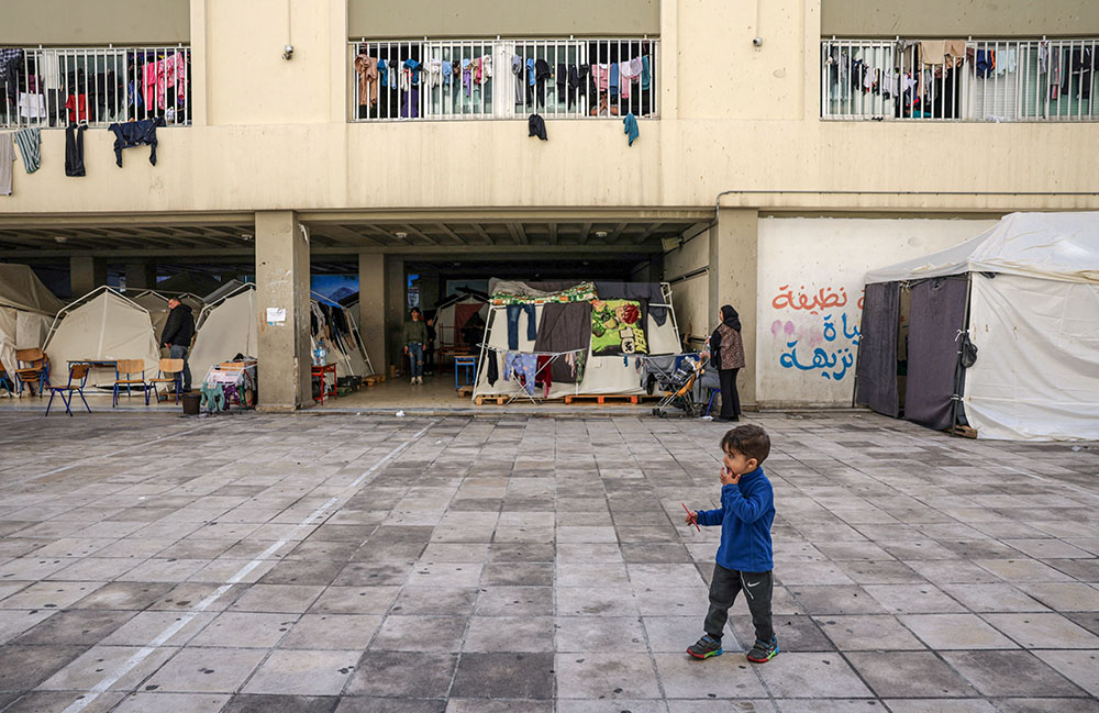 A child walks at a school turned into a shelter for displaced families in Beirut March 16, 2026, following an escalation in aerial attacks between Hezbollah and Israel, amid the U.S.-Israeli war with Iran. (OSV News/Reuters/Khalil Ashawi)