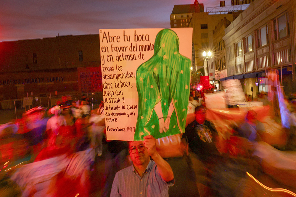 A man holds a placard with an image of Our Lady of Guadalupe during a protest in El Paso, Texas, March 24, 2026, against mass deportations and the immigration policies of the Trump administration. The sign, which quotes Proverbs 31:8-9, says, "Open your mouth in behalf of the mute, and for the rights of the destitute; open your mouth, judge justly, defend the needy and the poor." (OSV News/Jose Luis Gonzalez)