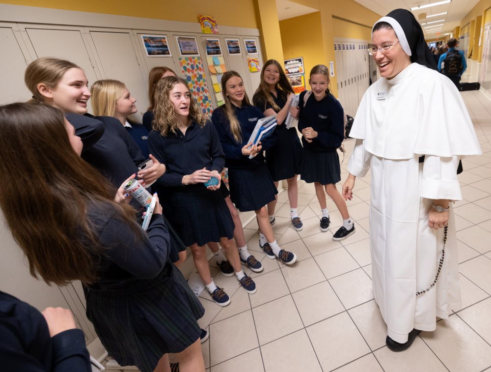 Sr. Amelia Hueller of the Dominican Sisters of St. Cecilia Congregation in Nashville, Tenn., greets students in the hallway Jan. 12, 2026, at Providence Academy in Plymouth, Minn., as part of her ministry at the school. (OSV News/Dave Hrbacek, The Catholic Spirit)