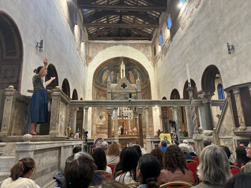 Allison Beyer of South Bend, Indiana, leads a group of pilgrims as they sing a psalm Oct. 6, 2024, at the Basilica of Santa Maria in Cosmedin during a pilgrimage to Rome for groups from the Ecclesial Conference of the Amazon (CEAMA) and Discerning Deacons. Both groups advocate for the ordination of women deacons. (GSR photo/Rhina Guidos) 
