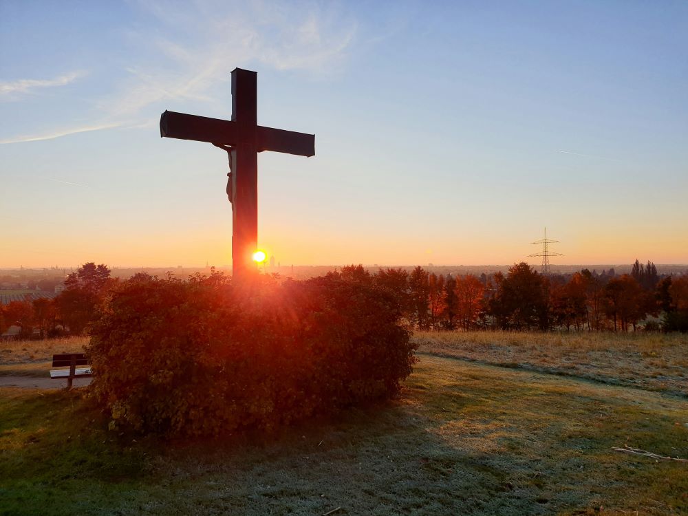 Back of crucifix silhouetted against sky