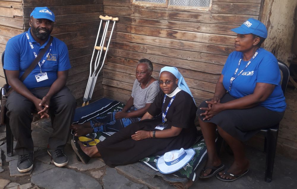 Sr. Alice Nyazungu and Jesuit Refugee Service community counselors visit an elderly person with physical disabilities in Tongogara Refugee Camp in Zimbabwe in March 2022. (Courtesy of Alice Nyazungu) 