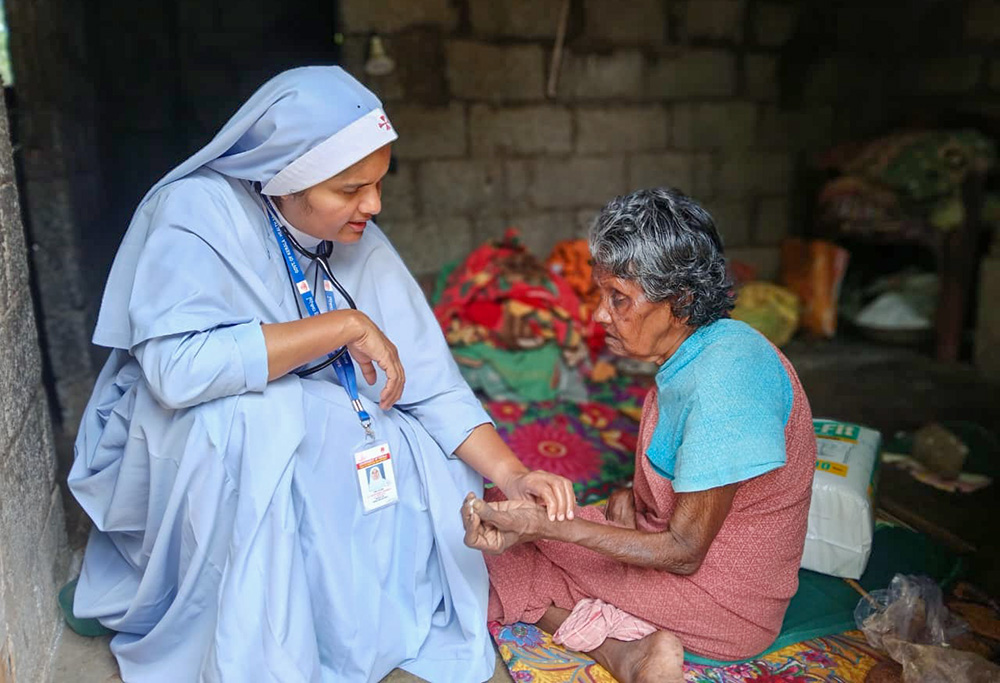 Sr. Jean Rose, a member of the Sisters of the Destitute and a medical doctor, gives palliative care to an elderly tribal woman at her home in the deep forests of Idukki district in Kerala, southwestern India. (Courtesy of Jean Rose)