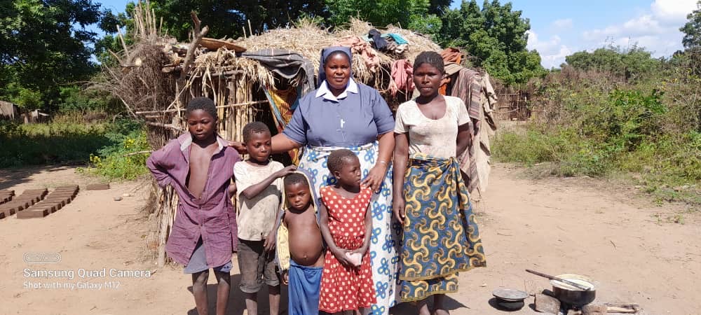 Fatima Katandika (right) and her four young children were driven from home by her husband. Mary Consoler of the Afflicted Sisters in Malawi assisted her to build a makeshift shelter and to start an income-generating project. (Courtesy of Mary Consoler of the Afflicted Sisters)
