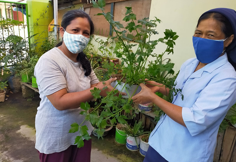 Sr. Gracia L. Suparti of the Daughters of Charity, right, with one of the members of the Migrant Family Association. In 2019, Suparti founded the Migrant Family Association in Garum, a small sub-district near Blitar's capital, to help migrant families with their expenses and navigating poverty-related issues. (Courtesy of the Daughters of Charity)