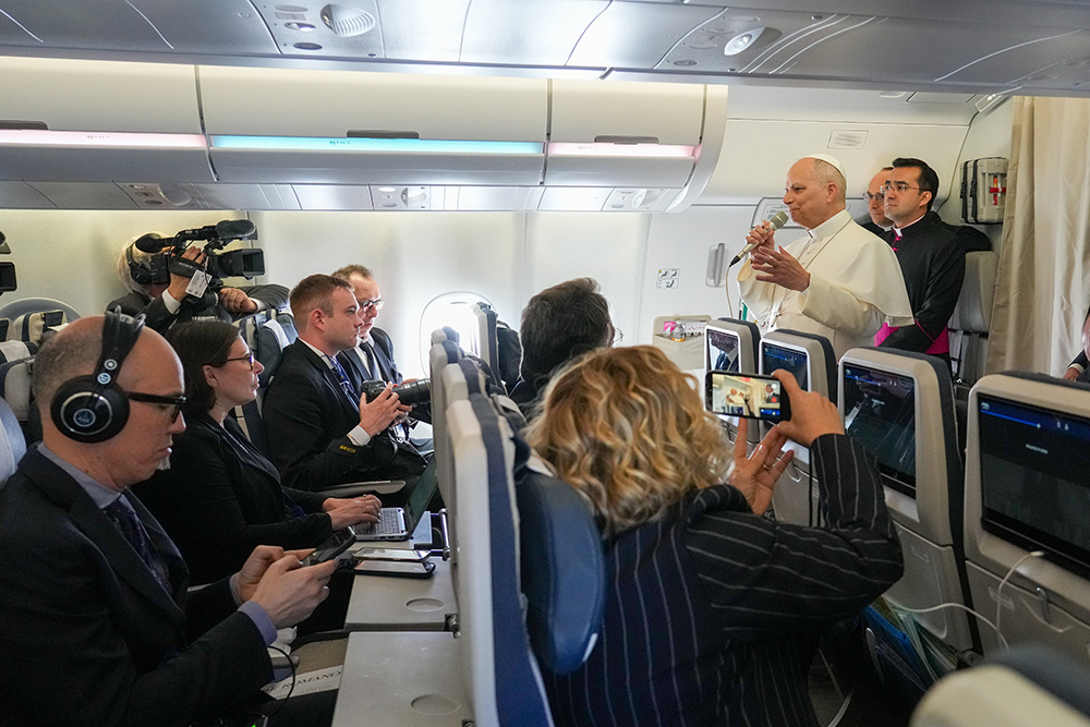 Pope Leo XIV speaks to reporters aboard the papal flight from Rome to Algeria April 13, 2026. (CNS/Lola Gomez)