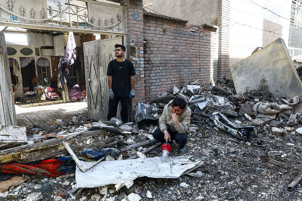 People react at the site of a residential building in Tehran, Iran, March 27, 2026, that was damaged by a strike amid the U.S.-Israeli war with Iran. (OSV News/West Asia News Agency via Reuters/Majid Asgaripour)