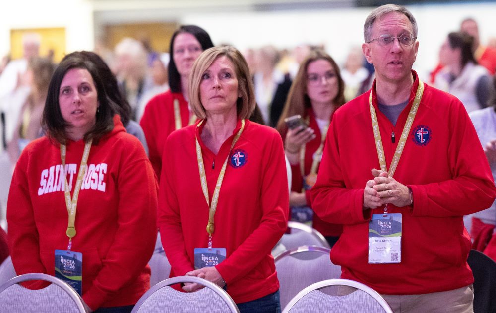 Teachers Susan Stanke, Eileen McGurran and Dave Gottwalt of St. Rose of Lima Catholic School in Roseville, Minn., pray during the closing Mass of the 2026 National Catholic Education Association Convention April 9 at the Minneapolis Convention Center in downtown Minneapolis. (OSV News photo/The Catholic Spirit/Dave Hrbacek)