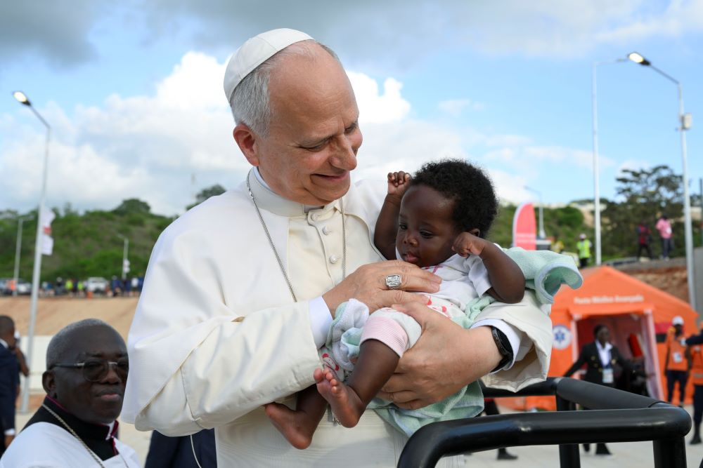 Pope Leo XIV holds a baby at the Sanctuary of Our Lady of Muxima in Muxima, Angola, April 19, 2026. (OSV News/Vatican Media/Simone Risoluti)