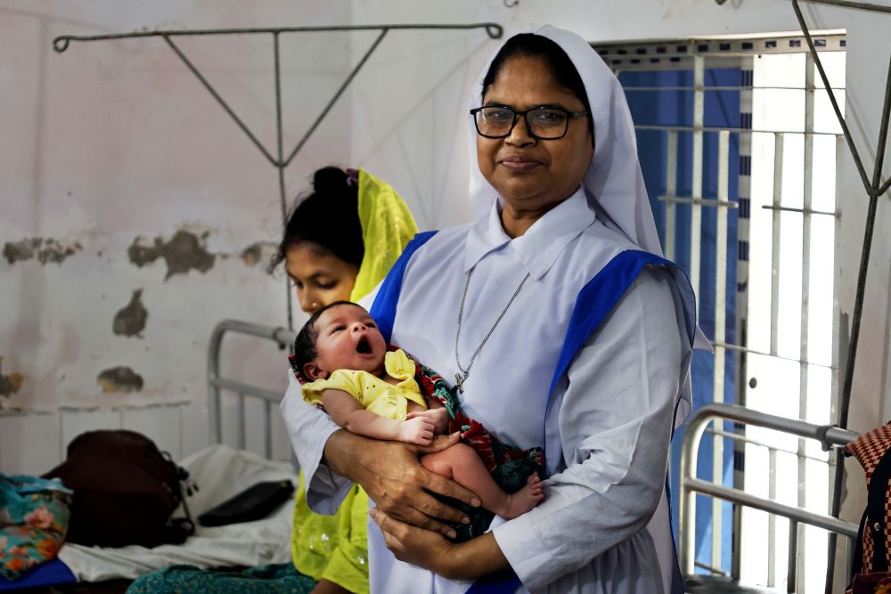 Sr. Mary Piusha holds a newborn baby at St. Paul's Hospital in Mongla, Bangladesh. The Associates of Mary Queen of the Apostles Sisters have been overseeing St. Paul's Hospital for 50 years. (Stephan Uttom Rozario)
