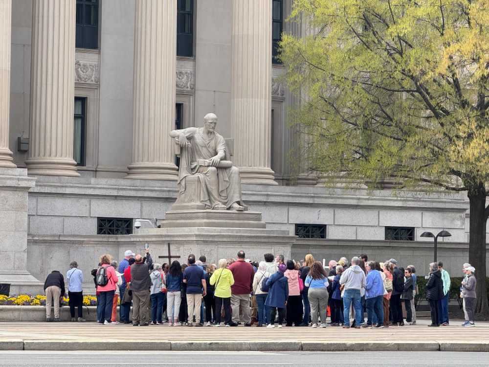 A group of Catholics and others gather at the National Archives building as they start to pray the Way of the Cross on Good Friday outside Washington institutions April 3, 2026. (NCR photo/Rhina Guidos)
