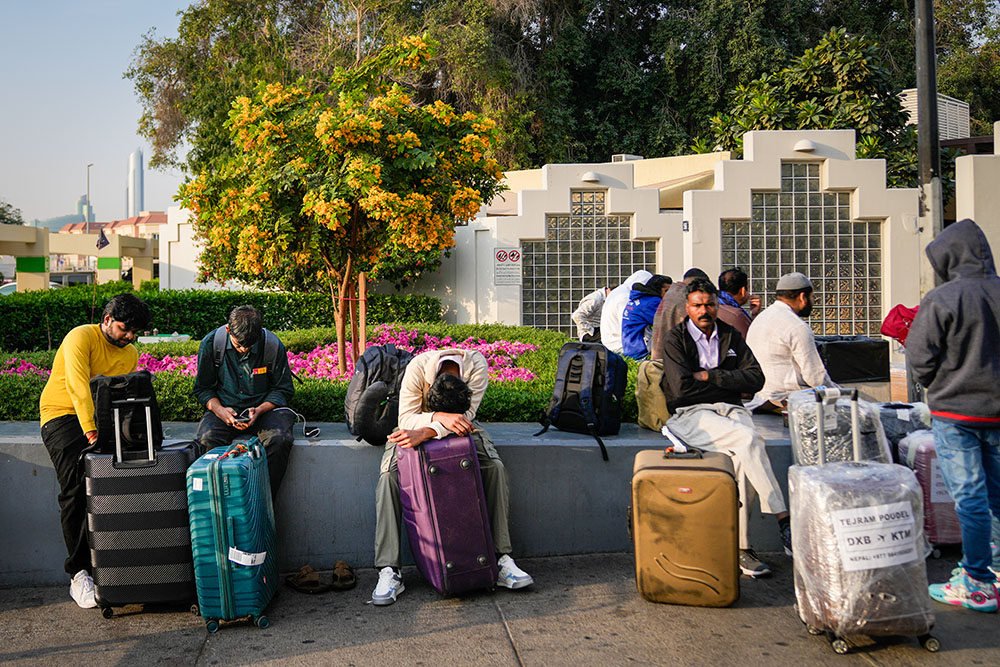 Passengers stranded by the closure of Dubai International Airport await assistance in the airport parking lot in Dubai, United Arab Emirates, March 1, 2026. (AP/Altaf Qadri)