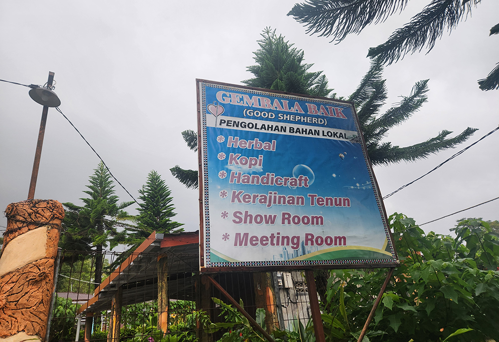 A sign outside the Sisters of the Good Shepherd's convent in Ruteng, Indonesia, notes the sisters' public ministries at the site, including a retreat center for church groups, and as an outlet for crafts made by women and the sale of coffee grown by farming communities near the sisters. (GSR photo/Chris Herlinger)