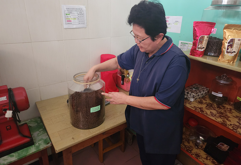 Good Shepherd Sr. Natalia Tanzil with coffee roasted and bagged on-site at the sisters' convent in Ruteng, Indonesia (GSR photo/Chris Herlinger)
