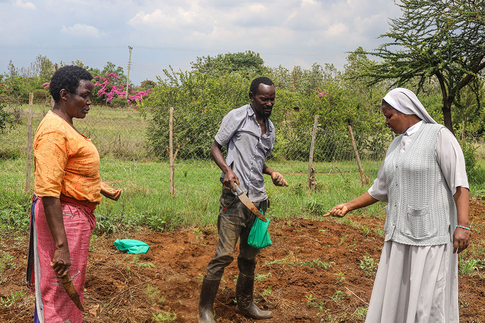 Mary Ledama, left, and Sr. Stella Cherobon plant crops at the Handmaids Social Enterprise farm in Tuala, Kenya. Catholic sisters working with Maasai communities are promoting drought-resistant farming as climate change threatens traditional pastoral livelihoods. (GSR photo/Doreen Ajiambo)